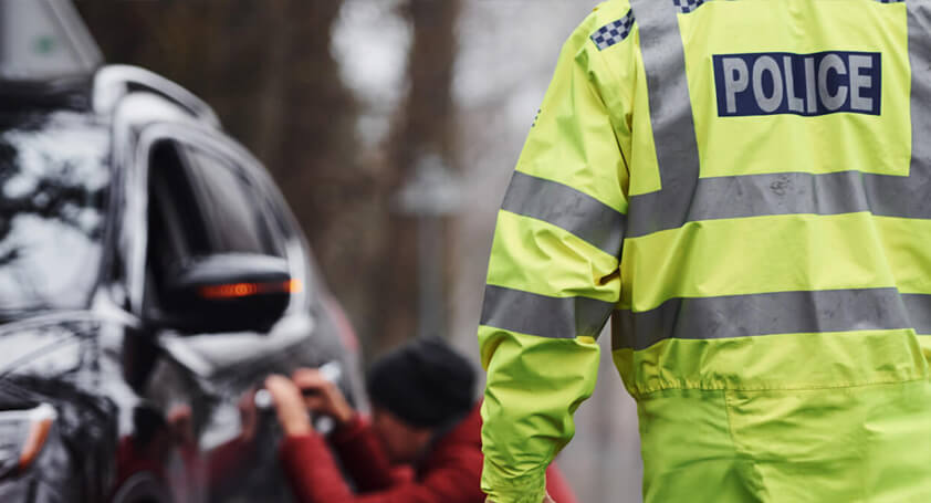 Police walking at the side of the road